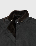 Load image into Gallery viewer, Close-up of a dark charcoal gray cashmere coat featuring a removable, plush dark brown fur collar and a silver snap button closure.