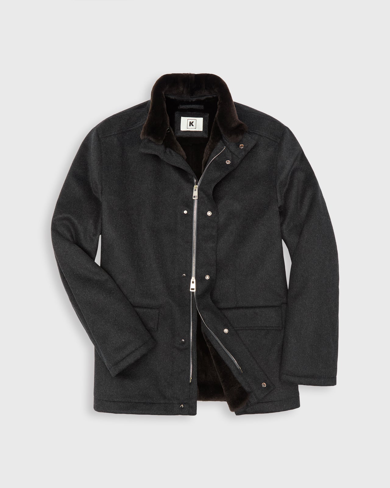 A dark charcoal gray cashmere jacket with a brown beaver fur lining and removable collar, two-way zipper and snap closures, shown on a light gray background.