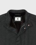 Load image into Gallery viewer, Close-up of a dark charcoal gray cashmere jacket with a brown beaver fur lining, featuring a hanger hook, zipper, and snap closures.
