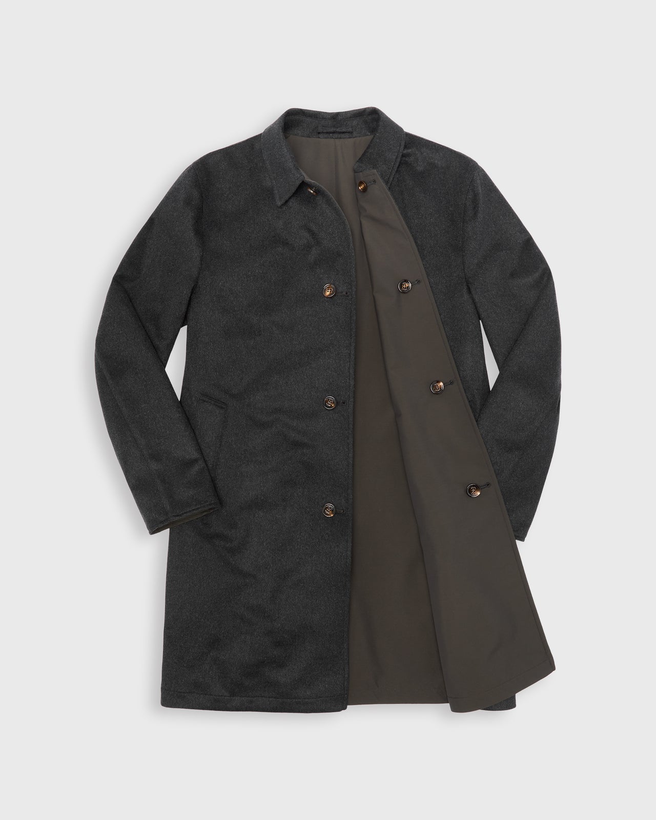 A dark charcoal gray single-breasted coat with a contrasting brown reversible lining, displayed flat against a light gray background.